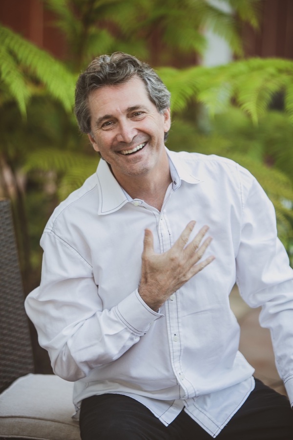 Dr. Danny Friedland, smiling, with his hand over his heart